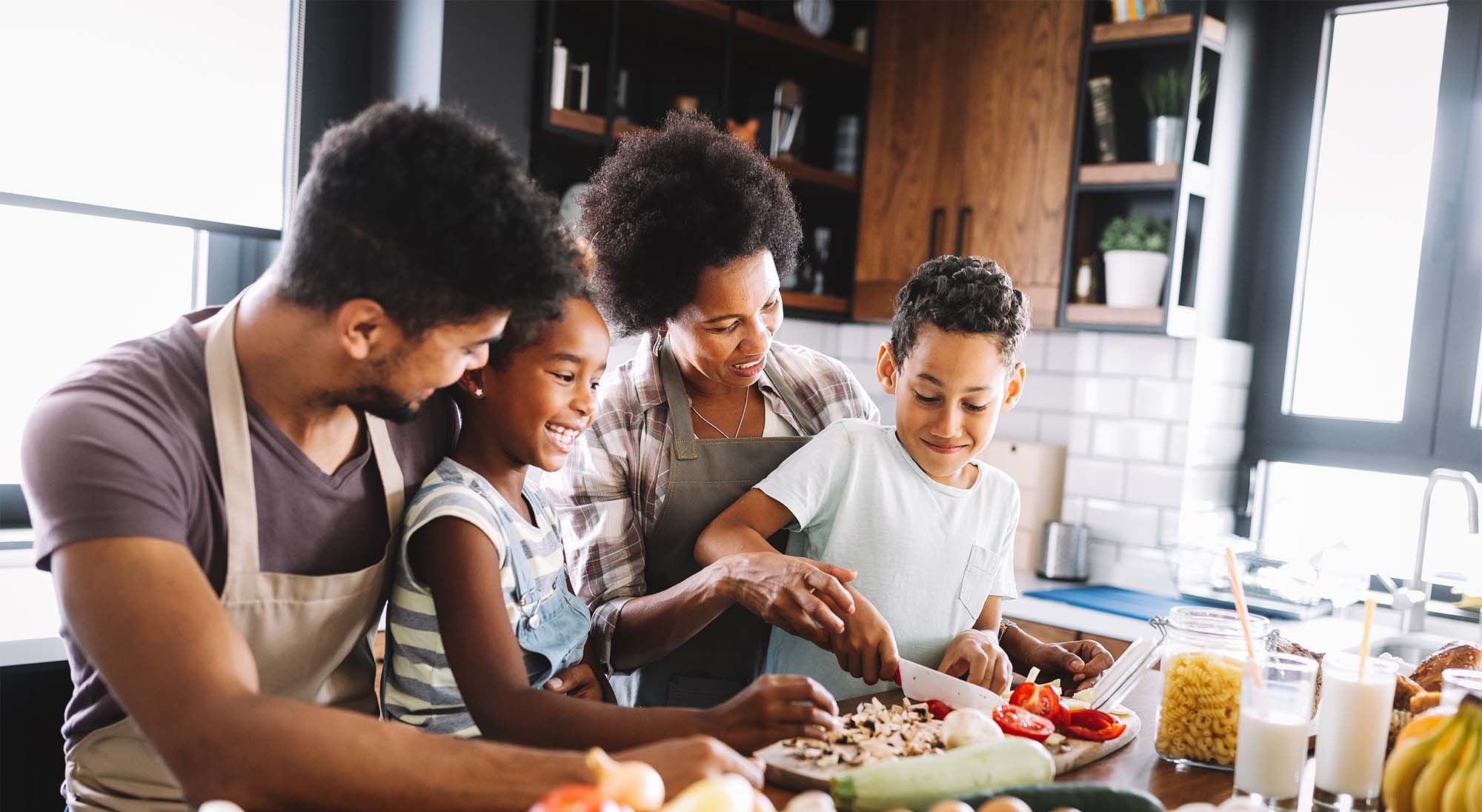 Family cooking healthy food together in a home kitchen